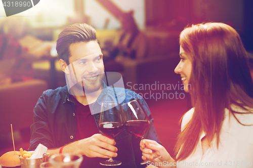 Image of couple dining and drinking wine at restaurant