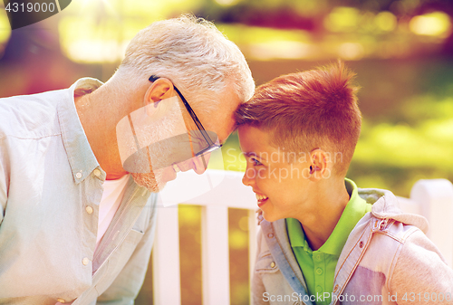 Image of grandfather and grandson at summer park