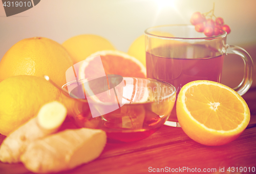 Image of tea with honey, lemon and ginger on wood