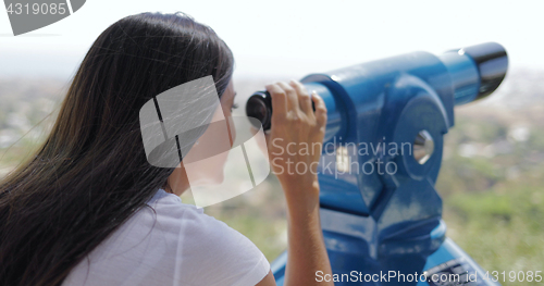 Image of Woman using spyglass on city viewpoint