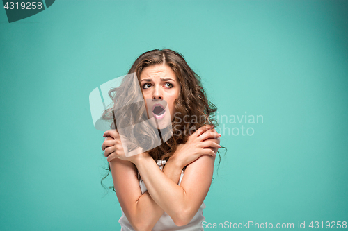 Image of Portrait of young woman with shocked facial expression