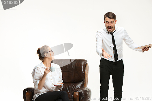 Image of The young man and beautiful woman in business suit at office on white background