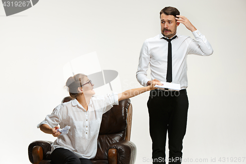 Image of The young man and beautiful woman in business suit at office on white background