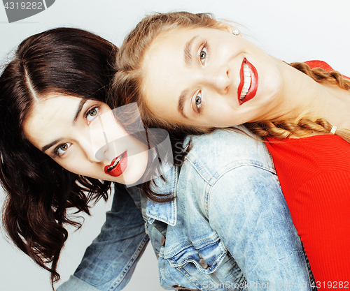 Image of best friends teenage girls together having fun, posing emotional on white background, besties happy smiling, lifestyle people concept close up