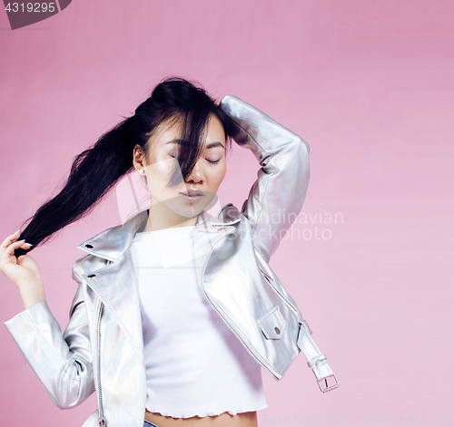 Image of young pretty smiling asian korean girl wearing modern fashion clothers on pink background, lifestyle people concept 