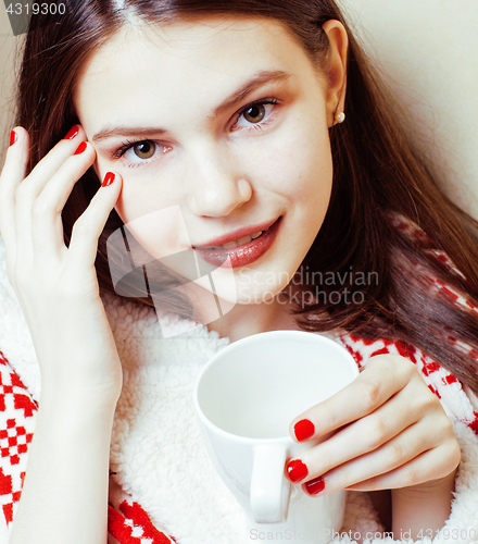 Image of young pretty brunette woman in her bedroom sitting at window, happy smiling lifestyle people concept 