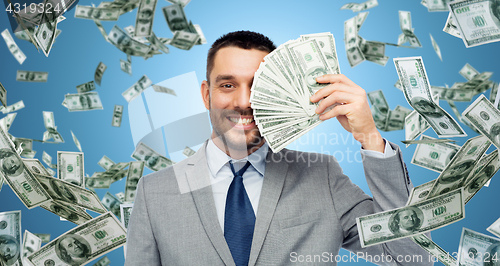 Image of smiling businessman with american dollar money