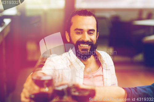 Image of happy man clinking glass of wine at restaurant