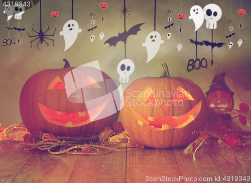 Image of carved pumpkins in witch hat and halloween garland