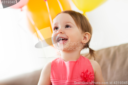 Image of happy baby girl on birthday party at home