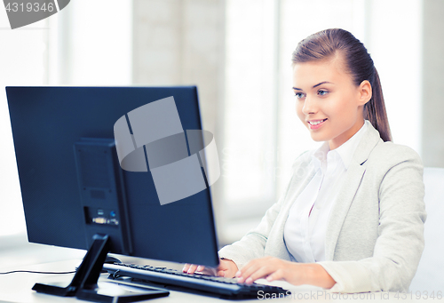 Image of businesswoman with computer in office