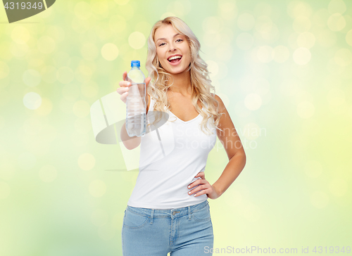Image of happy beautiful young woman with bottle of water