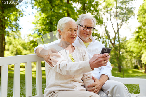 Image of senior couple with smartphone taking selfie 