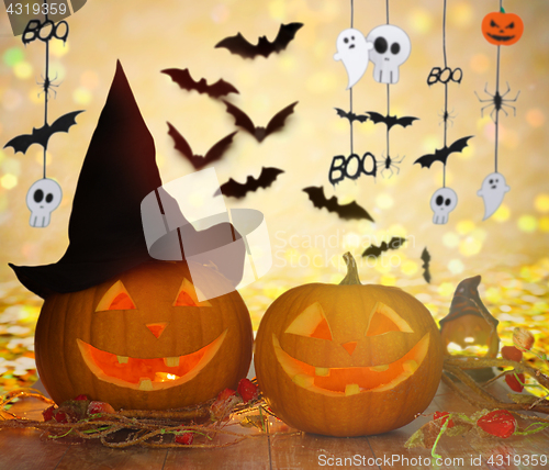 Image of carved pumpkins in witch hat and halloween garland