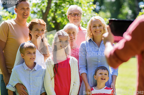 Image of happy family photographing by tablet pc in summer