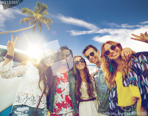 Image of hippie friends at minivan car showing peace sign