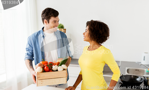 Image of happy couple with healthy food at home kitchen