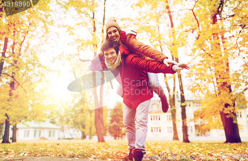 Image of happy young couple having fun in autumn park