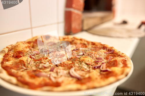 Image of baked pizza at pizzeria