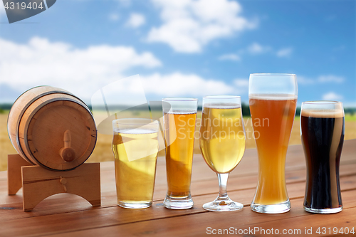 Image of different types of beer in glasses on table