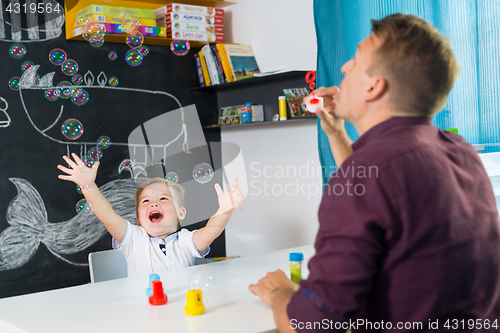 Image of Cute little toddler boy at speechtherapist session.