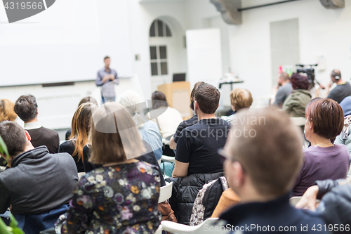 Image of Man giving presentation in lecture hall at university.