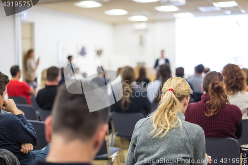 Image of Man giving presentation in lecture hall at university.