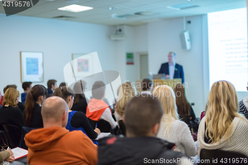 Image of Man giving presentation in lecture hall at university.