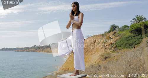 Image of Concentrated woman practicing yoga