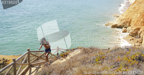 Image of woman walking up on nature