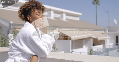 Image of Dreaming model on balcony of hotel