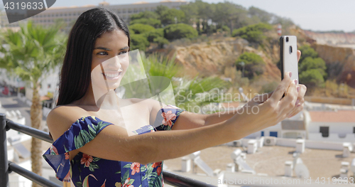 Image of Confident model taking selfie on resort