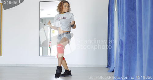 Image of Sportive woman dancing in studio