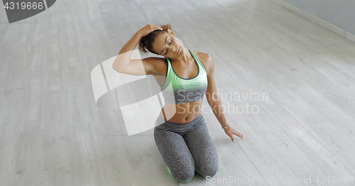 Image of Young woman stretching body