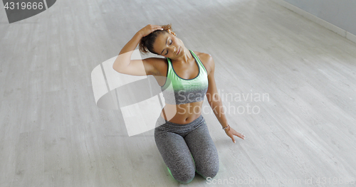 Image of Young woman stretching body