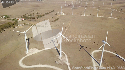 Image of Windmills producing electricity in desert