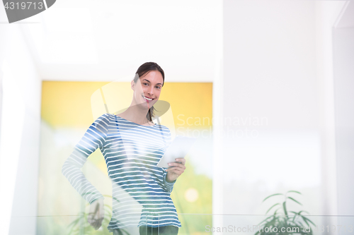 Image of young woman at home websurfing