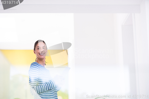 Image of young woman at home websurfing