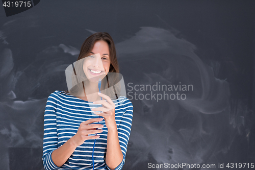 Image of woman holding a internet cable in front of chalk drawing board