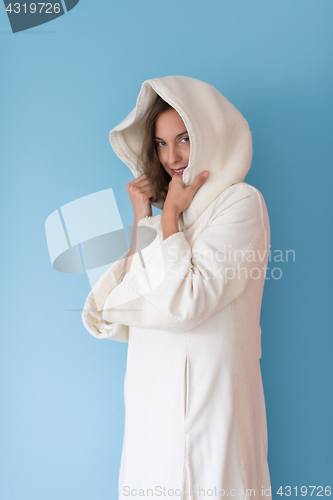 Image of woman in a white coat with hood isolated on blue background