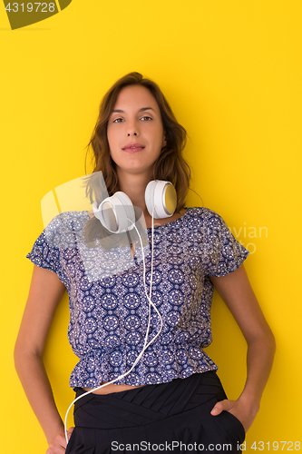 Image of woman with headphones isolated on a yellow