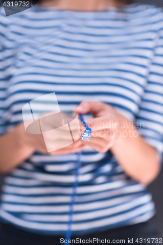 Image of woman holding a internet cable in front of chalk drawing board