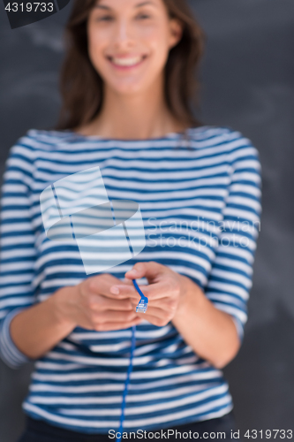 Image of woman holding a internet cable in front of chalk drawing board