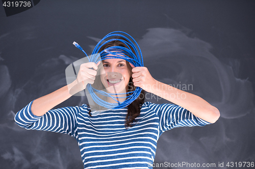 Image of woman holding a internet cable in front of chalk drawing board