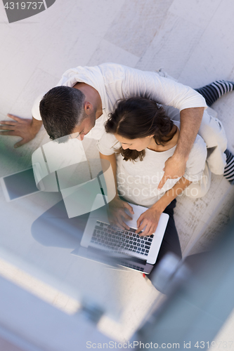 Image of couple using tablet and laptop computers top view