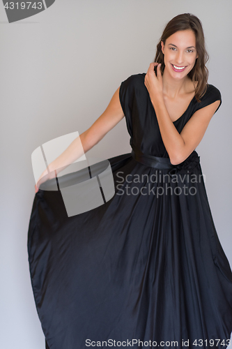 Image of woman in a black dress isolated on white background