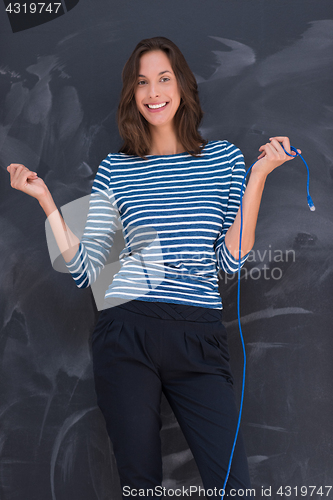 Image of woman holding a internet cable in front of chalk drawing board