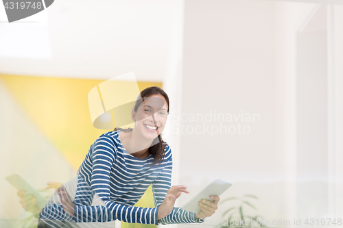 Image of young woman at home websurfing