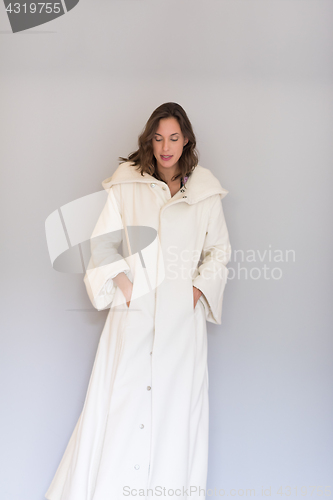 Image of woman in a white coat with hood isolated on white background