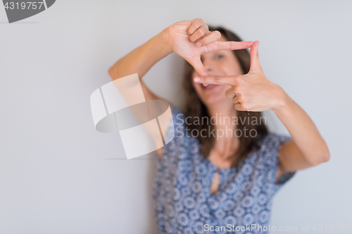 Image of woman showing framing hand gesture